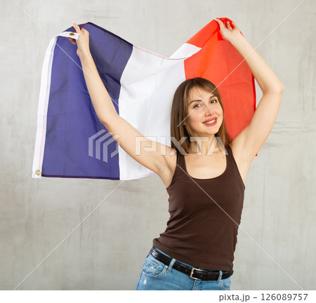 Young cheerful woman holding France flag 126089757