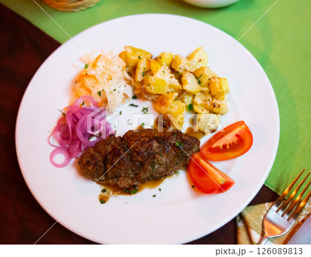 Plate with a meat dish lula-kebab and stewed potatoes. 126089813