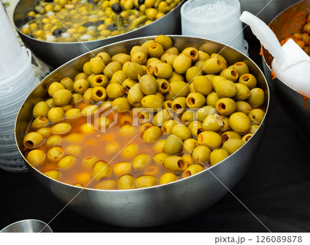 Pile of pitted green olives in bucket Pile of pitted green olives in bucket 126089878
