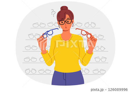 Woman buys glasses in store with large assortment of lenses and frames and chooses of two options 126089996