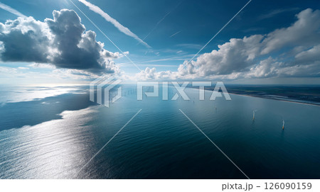 Towering wind turbines over the ocean, the seas harness the gentle sea breeze over the vast waters, demonstrating sustainable energy in action. Going Green Towering wind turbines over the ocean, the seas harness the gentle sea breeze over the vast waters, demonstrating sustainable energy in action. Going Green 126090159