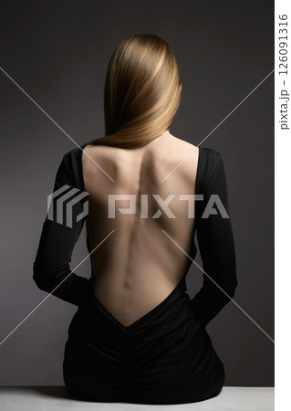 Beautiful Naked Back of blond Girl. Woman in Sexual elegant black dress 126091316
