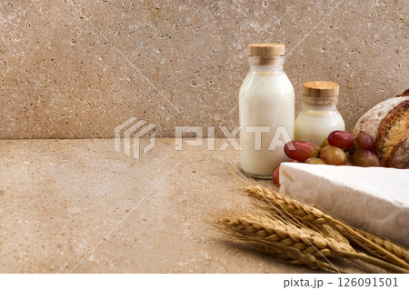 Jewish holiday Shavuot concept. Grains, milk and cheese on travertini stone background Jewish holiday Shavuot concept. Grains, milk and cheese on travertini stone background 126091501