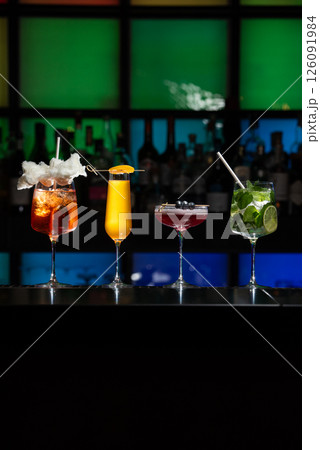 row of various colourfull alcoholic cocktails on a bar desk. Glasses of differen shapes 126091984