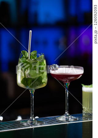row of various colourfull alcoholic cocktails on a bar desk. Glasses of differen shapes. selective focus 126092093
