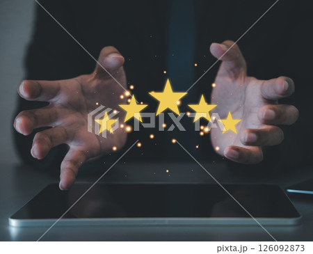 Happy customers are the backbone of any successful business. Show your satisfaction concept with a hand holding five shining stars. Customer service and Satisfaction concept Happy customers are the backbone of any successful business. Show your satisfaction concept with a hand holding five shining stars. Customer service and Satisfaction concept 126092873