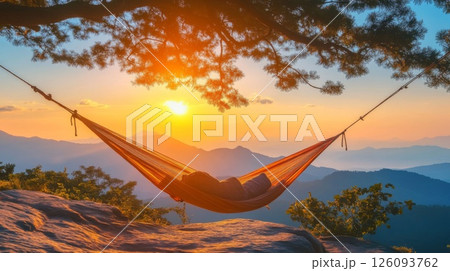 Relaxing in Hammock at Sunset Over Mountains 126093762