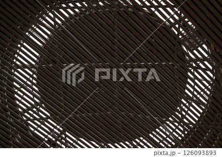 Abstract view of architectural ceiling with diagonal wooden slats, circular geometric frame design background, copy space. Concept of structure, modern architecture, minimalism Abstract view of architectural ceiling with diagonal wooden slats, circular geometric frame design background, copy space. Concept of structure, modern architecture, minimalism 126093893