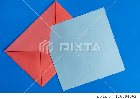 Red envelope and blue card with a minimalist design on a blue background. 126094662