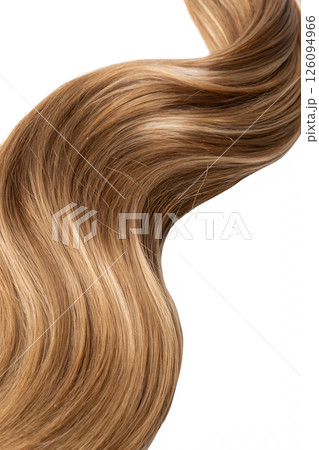 Close-up of a twisted strand of glossy light brown hair, shiny and smooth with natural highlights 126094966