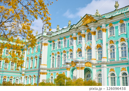 the incredibly picturesque facade of the Winter Palace through the branches of trees on a clear spring day, the heritage of Russia, the most famous landmark of St. Petersburg, the museum 126096438