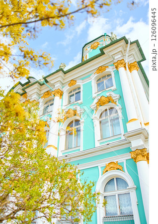 the incredibly picturesque facade of the Winter Palace through the branches of trees on a clear spring day, the heritage of Russia, the most famous landmark of St. Petersburg, the museum the incredibly picturesque facade of the Winter Palace through the branches of trees on a clear spring day, the heritage of Russia, the most famous landmark of St. Petersburg, the museum 126096445