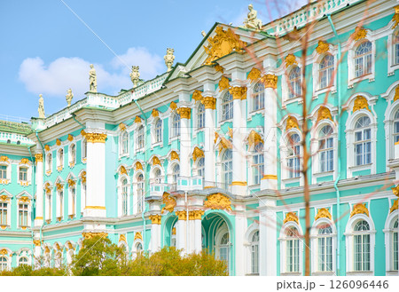 the incredibly picturesque facade of the Winter Palace through the branches of trees on a clear spring day, the heritage of Russia, the most famous landmark of St. Petersburg, the museum the incredibly picturesque facade of the Winter Palace through the branches of trees on a clear spring day, the heritage of Russia, the most famous landmark of St. Petersburg, the museum 126096446