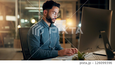 Night, business man and typing on computer for email, report or compliance officer on deadline. Keyboard, writing and serious worker reading research, regulations and policy development in office 126099396