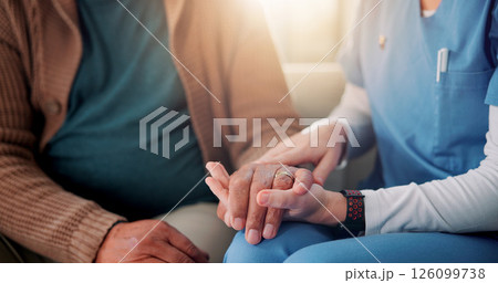 Sofa, caregiver and senior patient with holding hands for support, empathy and console for medical news. Home, nurse and old person with consultation for wellness, compassion and flare in closeup Sofa, caregiver and senior patient with holding hands for support, empathy and console for medical news. Home, nurse and old person with consultation for wellness, compassion and flare in closeup 126099738