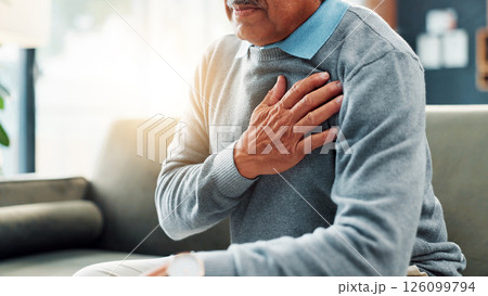 Heart attack, hand and senior man in home, sick and emergency for pensioner, strain and high blood pressure. House, healthcare risk and elderly person with coronary artery disease, chest pain and ill 126099794