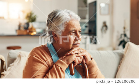 Sad, senior woman and thinking with cane in home for retirement loneliness, grief and nostalgia with memory. Stress, mental health or elderly person with walking stick on sofa for loss and reflection Sad, senior woman and thinking with cane in home for retirement loneliness, grief and nostalgia with memory. Stress, mental health or elderly person with walking stick on sofa for loss and reflection 126100200