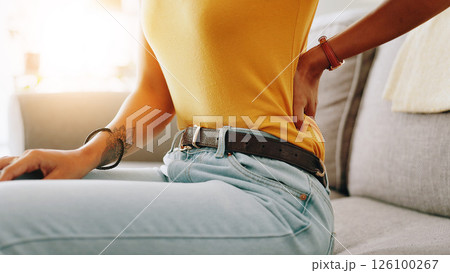 Woman, hand and back pain with injury on sofa for discomfort, muscle tension or strain at home. Closeup, female person or ache with sore spine for pressure, bad posture or bruise on couch at house Woman, hand and back pain with injury on sofa for discomfort, muscle tension or strain at home. Closeup, female person or ache with sore spine for pressure, bad posture or bruise on couch at house 126100267