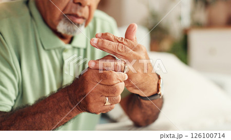 Ring, hands and senior man in home with divorce, cheating or toxic marriage in living room. Infidelity, guilt and elderly male person with jewelry removal for breakup, regret or relationship mistake. 126100714