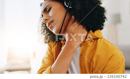 Woman, remote work and neck pain with headset, burnout and massage muscle in home. Virtual assistant, African person and injury in agency with bad posture, frustrated and overworked consultant 126100742