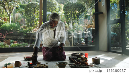 Incense, alternative medicine and mature man on floor for spiritual meditation, holistic treatment and healing. Aromatherapy, cleanse and person with stones for balance, chakra and detox for wellness Incense, alternative medicine and mature man on floor for spiritual meditation, holistic treatment and healing. Aromatherapy, cleanse and person with stones for balance, chakra and detox for wellness 126100987