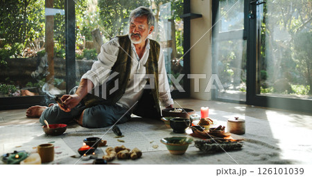 Crystal, alternative medicine and Asian man for spiritual meditation, holistic treatment and healing on floor. Aromatherapy, incense and healer with stones for peace, chakra and detox for wellness 126101039