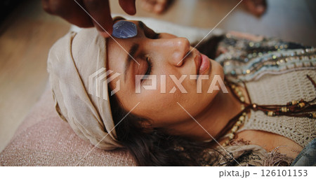 Woman, crystal and forehead with hands for chakra on floor, energy and therapy with rest on vacation. People, rocks and holistic care with mineral, mindfulness or peace for zen with balance at resort Woman, crystal and forehead with hands for chakra on floor, energy and therapy with rest on vacation. People, rocks and holistic care with mineral, mindfulness or peace for zen with balance at resort 126101153