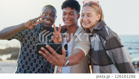 Friends, people and selfie with peace sign at beach for social media post, travel memory or profile picture update. Happy, group and photography on holiday adventure with bonding, support or vacation 126101288