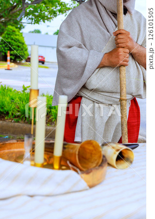 Arab Bedouin dressed in historical attire stands next to table candles interesting artifacts 126101505