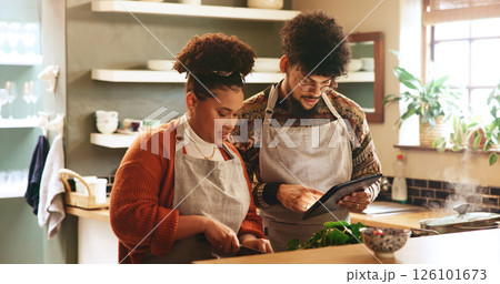 Couple, tablet and cooking in kitchen with search for recipe, video or guide for meal prep in home. People, man and woman with digital touchscreen, app or partner for food, nutrition or diet in house Couple, tablet and cooking in kitchen with search for recipe, video or guide for meal prep in home. People, man and woman with digital touchscreen, app or partner for food, nutrition or diet in house 126101673