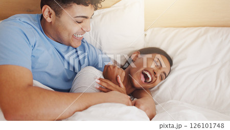 Love, tickle and couple laughing in bed together for morning affection, bonding or wake up. Excited, cuddle or joke with man and happy woman in apartment for funny humor, marriage or relationship Love, tickle and couple laughing in bed together for morning affection, bonding or wake up. Excited, cuddle or joke with man and happy woman in apartment for funny humor, marriage or relationship 126101748