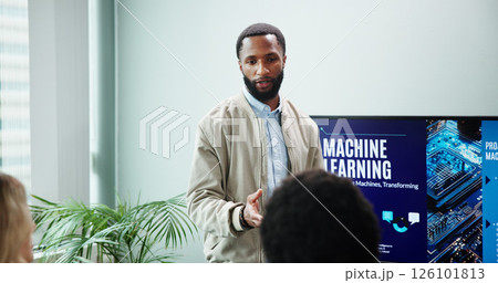 Business man, talking and machine learning presentation for new innovation, idea and ai product promotion. Speaker, office and pitch proposal to team for equity funding or tech workshop with screen Business man, talking and machine learning presentation for new innovation, idea and ai product promotion. Speaker, office and pitch proposal to team for equity funding or tech workshop with screen 126101813