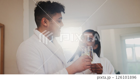 Couple, champagne and toast with happiness for anniversary, honeymoon or holiday accommodation. Love, bonding and commitment with drinks for cheers, interracial people and vacation getaway in hotel 126101896