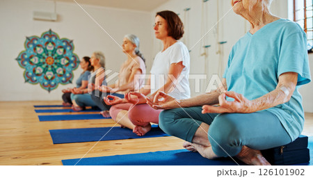 Mature, lotus and women with meditation class for calm mindset, zen or peace in mental wellness. Posture, morning and people in group together for mindfulness, relax or holistic self care on yoga mat 126101902