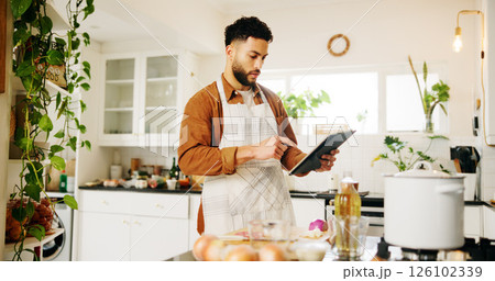 Man, tablet and cooking with kitchen, recipe and home with food ingredients and internet instructions. Technology, blog and preparation with chef person in apartment for diet, health or nutrition 126102339