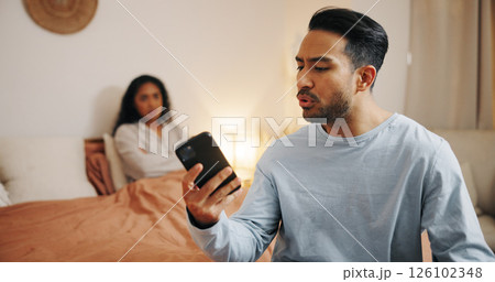 Frustrated couple, phone and bed with fight for cheating affair, trust issues or argument at home. Upset, man or woman with mobile smartphone in bedroom for toxic relationship, conflict or divorce 126102348