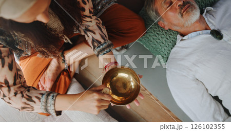 Tibetan bowl, relax and hands of person in studio for wellness retreat, healing and meditation. Chakra balance, peace and sound therapy with above of shaman for energy, holistic ritual and harmony Tibetan bowl, relax and hands of person in studio for wellness retreat, healing and meditation. Chakra balance, peace and sound therapy with above of shaman for energy, holistic ritual and harmony 126102355