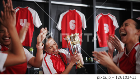 Happy women, soccer team and celebration with trophy for winning, victory or tournament in locker room. Excited, female people or sports players with smile for competition, success or award together Happy women, soccer team and celebration with trophy for winning, victory or tournament in locker room. Excited, female people or sports players with smile for competition, success or award together 126102413
