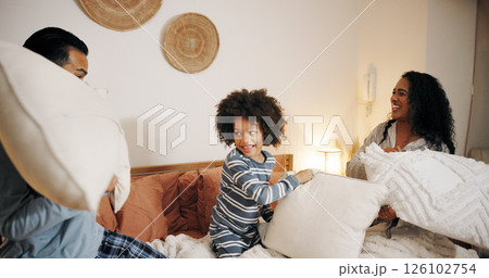 Happy family, bedroom or playing with pillow fight for fun bonding, game or holiday together at home. Dad, mom and playful child enjoying weekend, activity or cushion war with pajamas in bed at house Happy family, bedroom or playing with pillow fight for fun bonding, game or holiday together at home. Dad, mom and playful child enjoying weekend, activity or cushion war with pajamas in bed at house 126102754