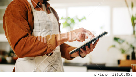 Hands, tablet and man in kitchen, cooking and connection with online recipe, app and instructions. Closeup, person and chef with tech, home and internet with ingredients, network or website for food Hands, tablet and man in kitchen, cooking and connection with online recipe, app and instructions. Closeup, person and chef with tech, home and internet with ingredients, network or website for food 126102859