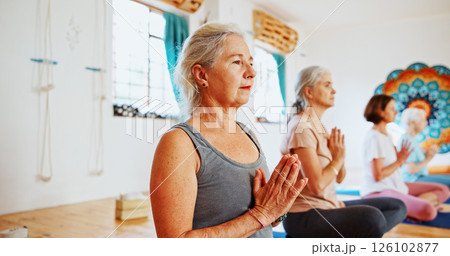 Hands, namaste and mature women with meditation for calm mindset, zen or peace in mental wellness. Posture, morning and people in class together for mindfulness, relax or holistic self care in yoga 126102877