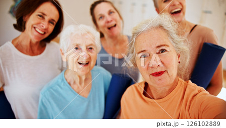 Selfie, senior and smile with woman friends in yoga class together for fitness, health or wellness. Exercise, profile picture and social media with group of old people in studio for photograph 126102889