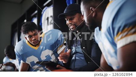 Tablet, coaching and football team with men in locker room for game plan, sports strategy or defense formation. Touchdown tactics, match feedback and discussion with people and advice for training Tablet, coaching and football team with men in locker room for game plan, sports strategy or defense formation. Touchdown tactics, match feedback and discussion with people and advice for training 126102894