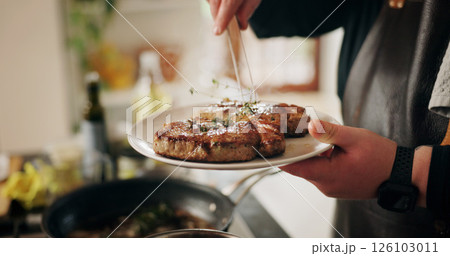 Hands, chef and plate with steak, kitchen and preparation for beef in restaurant or culinary skills. Catering business, process and person with presentation of meat, hospitality or herbs for gourmet 126103011