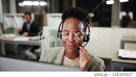 Call center, woman and listen on computer for telemarketing, sales and CRM at night. Happy agent, contact us and customer service with headset for lead generation, inbound marketing and overtime 126103027