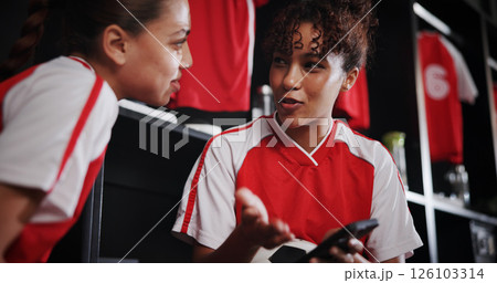 Talking, smile and girls with smartphone, gym and conversation for match on website, watching and sports. Locker room, friends and people with mobile for streaming, scroll and preparing for game Talking, smile and girls with smartphone, gym and conversation for match on website, watching and sports. Locker room, friends and people with mobile for streaming, scroll and preparing for game 126103314