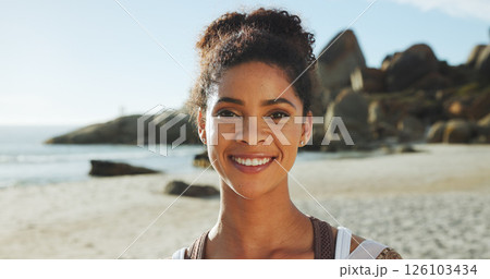 Beach, happy woman and travel in portrait for holiday, peace and summer break with confidence. Ocean, female person and outdoor with smile for adventure, vacation and tourist for exploration by sea 126103434