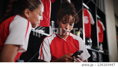 Talking, team and girls with smartphone, gym and conversation for match on website, watching and sports. Locker room, friends and people with mobile for streaming, scroll and preparing for game Talking, team and girls with smartphone, gym and conversation for match on website, watching and sports. Locker room, friends and people with mobile for streaming, scroll and preparing for game 126103447
