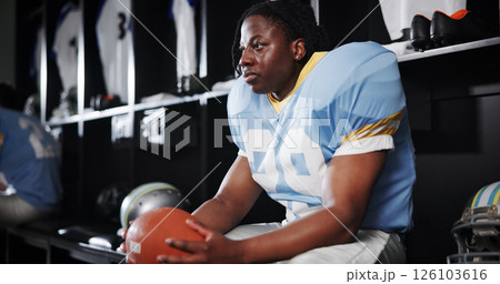 Thinking, black man and player for football in locker room for preparation, sports match and game plan. Athlete, waiting and half time for competition ideas, fitness challenge and tournament choice Thinking, black man and player for football in locker room for preparation, sports match and game plan. Athlete, waiting and half time for competition ideas, fitness challenge and tournament choice 126103616