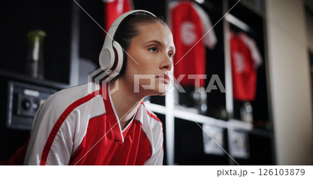 Thinking, soccer and woman with headphones in locker room for music, audio and radio for training. Football, rest and person with track for exercise, fitness or workout for match, game and practice Thinking, soccer and woman with headphones in locker room for music, audio and radio for training. Football, rest and person with track for exercise, fitness or workout for match, game and practice 126103879